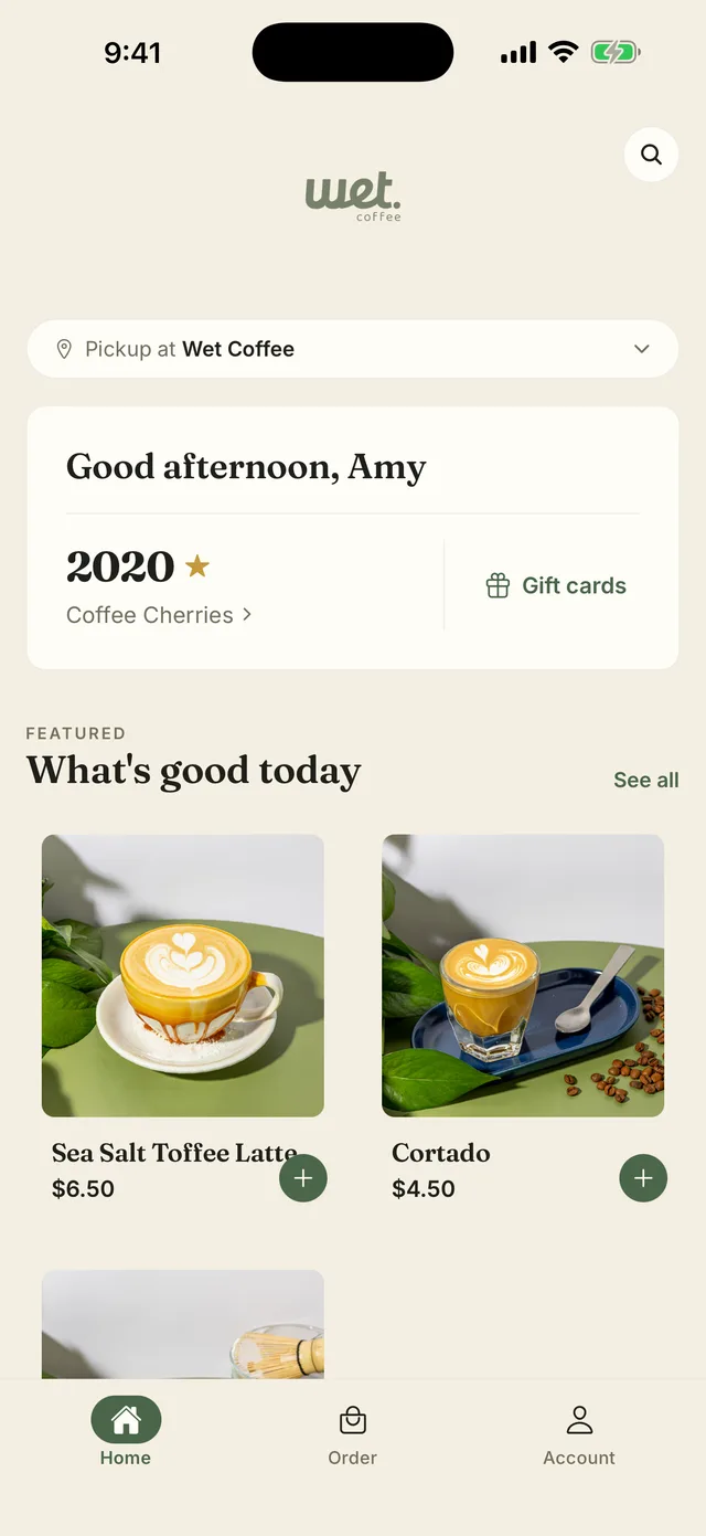The Wet Coffee app — a real shop's branded iPhone app built on Tany, showing pickup location, loyalty balance and featured drinks